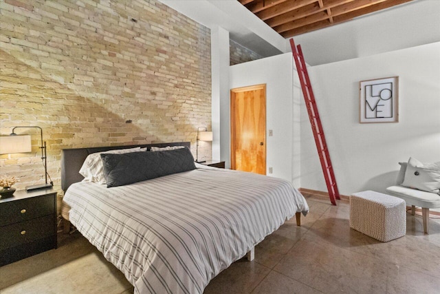 771 N Water St Unit 25, Milwaukee, WI 53202 - bedroom featuring brick wall and a towering ceiling