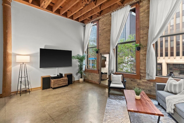 771 N Water St Unit 25, Milwaukee, WI 53202 - living area featuring baseboards, a towering ceiling, and concrete flooring