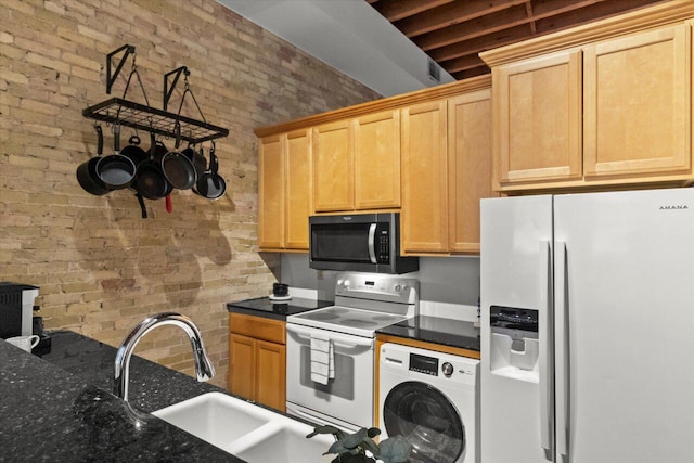 771 N Water St Unit 25, Milwaukee, WI 53202 - kitchen with refrigerator with ice dispenser, stainless steel microwave, washer / dryer, white electric range oven, and brick wall