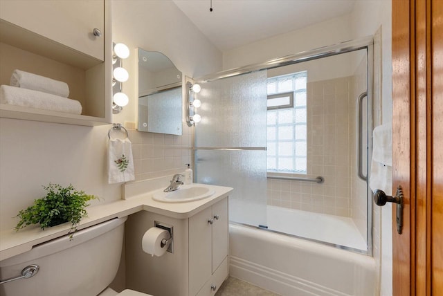 2147 S 90th St, West Allis, WI 53227 - full bathroom featuring toilet, vanity, bath / shower combo with glass door, and tasteful backsplash