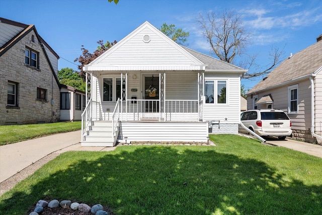 2147 S 90th St, West Allis, WI 53227 - bungalow-style house featuring covered porch and a front yard
