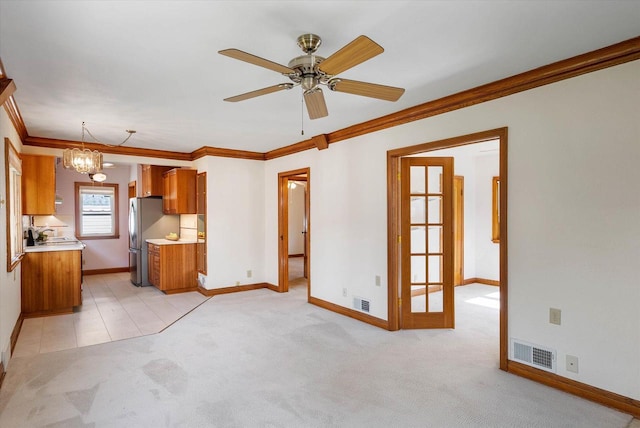 2147 S 90th St, West Allis, WI 53227 - kitchen with brown cabinetry, ornamental molding, freestanding refrigerator, light countertops, and light carpet