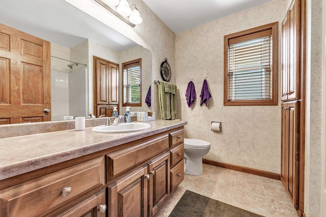 3611 Glen Kent Ct, Green Bay, WI 54313 - bathroom featuring vanity, toilet, baseboards, a shower, and tile patterned flooring