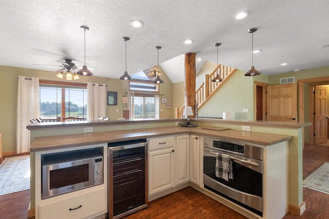 N8092 15th Ave, New Lisbon, WI 53950 - kitchen featuring beverage cooler, appliances with stainless steel finishes, a textured ceiling, dark wood finished floors, and pendant lighting