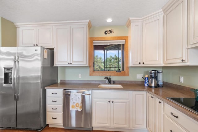 N8092 15th Ave, New Lisbon, WI 53950 - kitchen with stainless steel appliances, a sink, white cabinetry, and recessed lighting