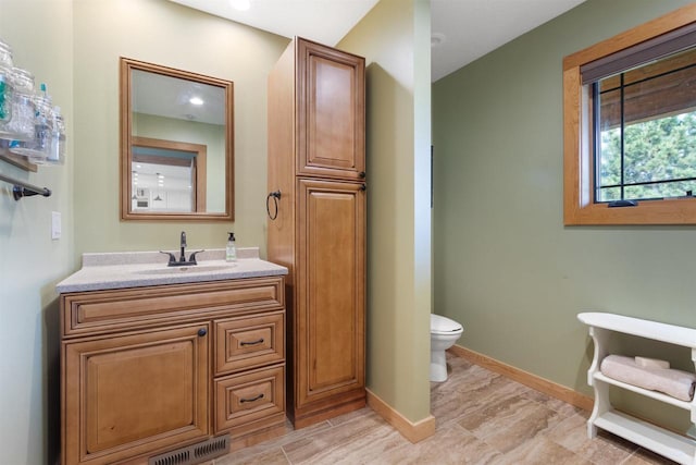 N8092 15th Ave, New Lisbon, WI 53950 - bathroom featuring vanity, toilet, and baseboards