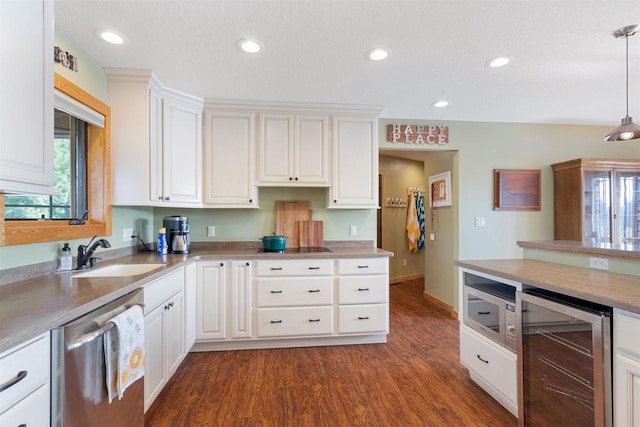 N8092 15th Ave, New Lisbon, WI 53950 - kitchen with wine cooler, stainless steel appliances, a sink, dark wood-style flooring, and decorative light fixtures