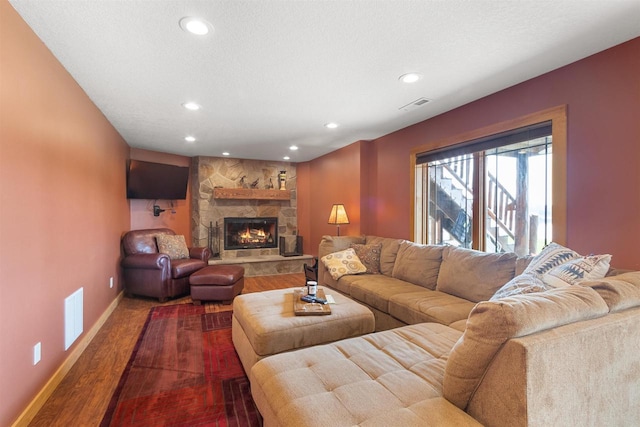 N8092 15th Ave, New Lisbon, WI 53950 - living area featuring dark wood-style floors, recessed lighting, baseboards, and a stone fireplace