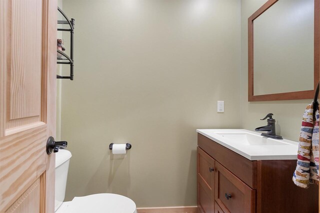 N8092 15th Ave, New Lisbon, WI 53950 - half bathroom featuring vanity, toilet, and baseboards