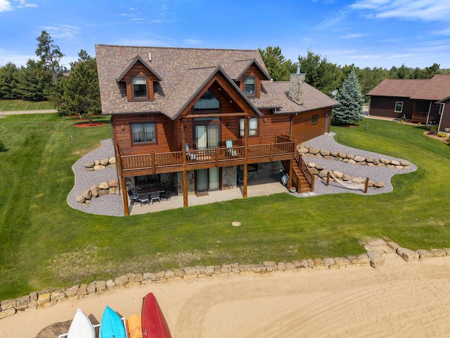 N8092 15th Ave, New Lisbon, WI 53950 - back of property with a patio area, a wooden deck, a lawn, stairs, and a shingled roof