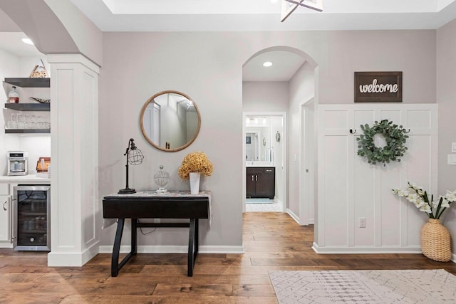 5660 N Osprey Dr, Appleton, WI 54913 - hall with wine cooler, wood-type flooring, arched walkways, baseboards, and recessed lighting