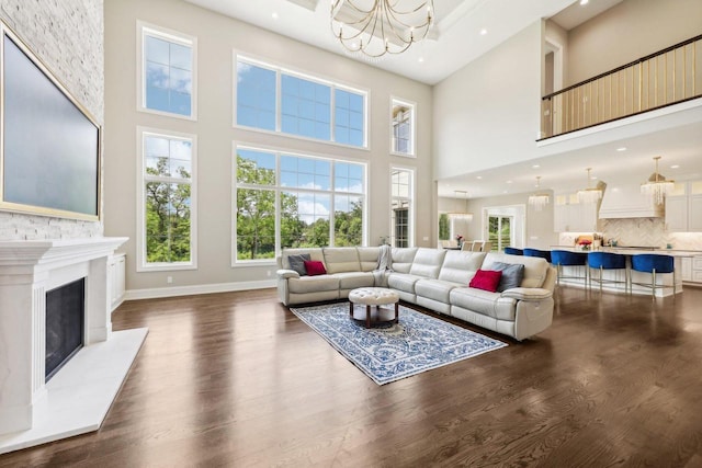 10031 N Range Line Rd, Mequon, WI 53092 - living room with a chandelier, dark wood finished floors, a high ceiling, recessed lighting, and a fireplace
