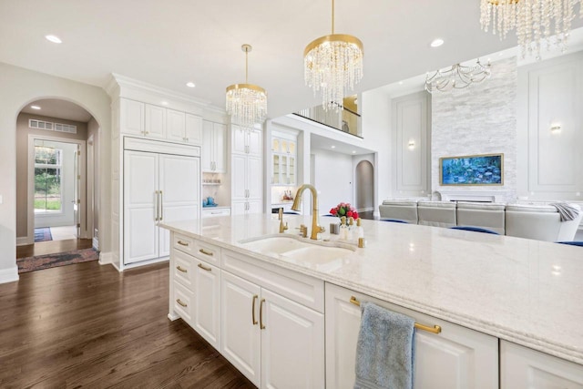 10031 N Range Line Rd, Mequon, WI 53092 - kitchen with arched walkways, a chandelier, white cabinets, and recessed lighting