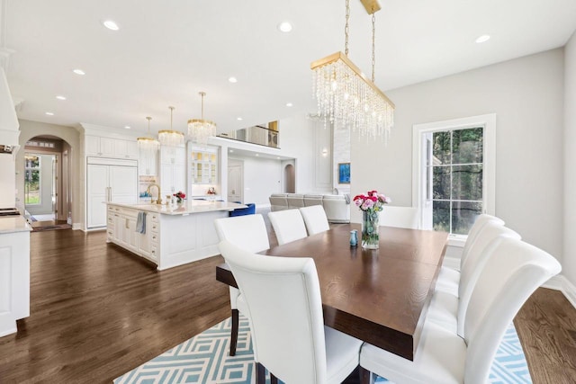 10031 N Range Line Rd, Mequon, WI 53092 - dining area featuring arched walkways, healthy amount of natural light, dark wood-type flooring, and recessed lighting