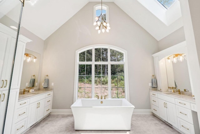 10031 N Range Line Rd, Mequon, WI 53092 - bathroom featuring high vaulted ceiling, vanity, a chandelier, a soaking tub, and a skylight