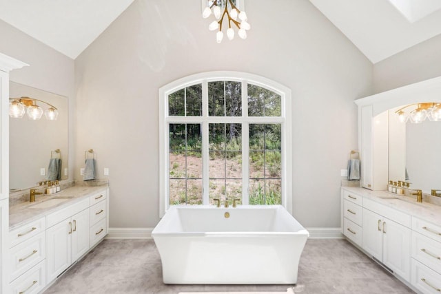 10031 N Range Line Rd, Mequon, WI 53092 - full bathroom featuring plenty of natural light, high vaulted ceiling, two vanities, a soaking tub, and a chandelier