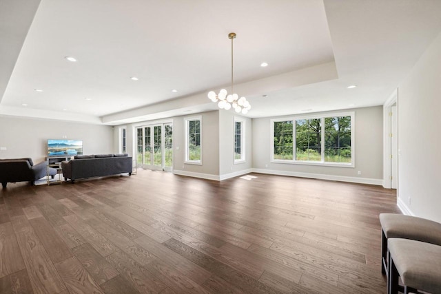 10031 N Range Line Rd, Mequon, WI 53092 - living room with dark wood-style flooring, a tray ceiling, and recessed lighting