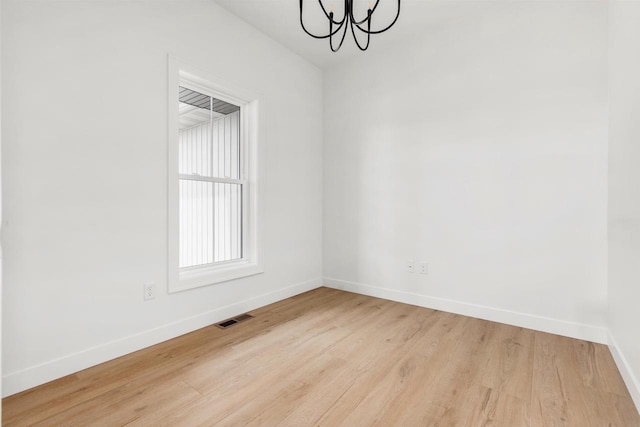 2590 N Stellita Cir, De Pere, WI 54115 - empty room with a chandelier, baseboards, and wood finished floors