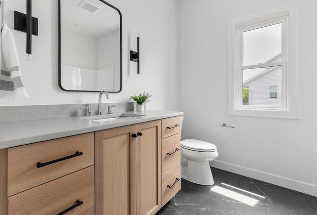 2590 N Stellita Cir, De Pere, WI 54115 - bathroom with baseboards, vanity, toilet, and marble finish floors