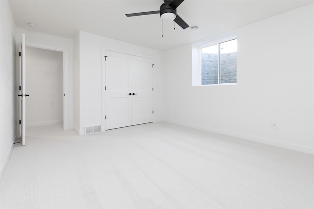 2590 N Stellita Cir, De Pere, WI 54115 - unfurnished bedroom with light carpet, a closet, baseboards, and ceiling fan