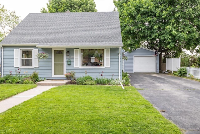 W62N322 Hanover Ave, Cedarburg, WI 53012 - view of front of house with an outbuilding, a detached garage, a shingled roof, and asphalt driveway