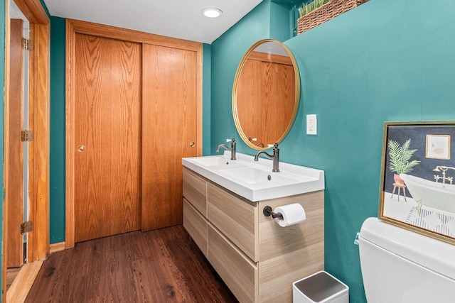 W62N322 Hanover Ave, Cedarburg, WI 53012 - bathroom with toilet, wood finished floors, double vanity, and recessed lighting
