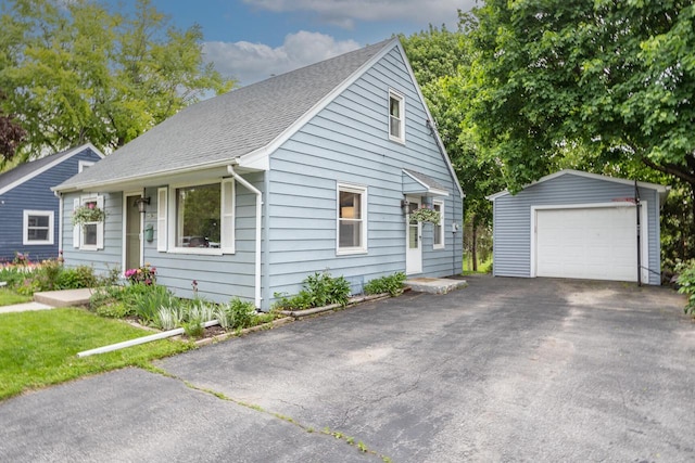 W62N322 Hanover Ave, Cedarburg, WI 53012 - view of front of house with an outdoor structure, a garage, asphalt driveway, and a shingled roof