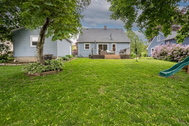W62N322 Hanover Ave, Cedarburg, WI 53012 - back of house featuring a wooden deck, a lawn, a playground, and a chimney