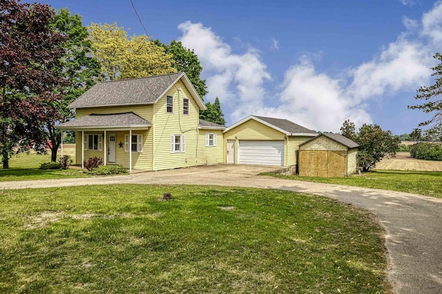 N3438 State Rd 76, Hortonville, WI 54944 - view of front of house featuring driveway, an outdoor structure, a front yard, a shingled roof, and a garage