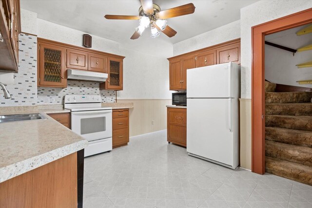 8511 W Orchard St, West Allis, WI 53214 - kitchen with white appliances, a sink, under cabinet range hood, brown cabinets, and a ceiling fan