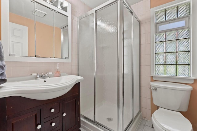 8511 W Orchard St, West Allis, WI 53214 - full bath featuring vanity, toilet, a shower stall, tile walls, and decorative backsplash