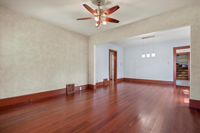 8511 W Orchard St, West Allis, WI 53214 - unfurnished room with wood finished floors, ceiling fan, stairway, and baseboards
