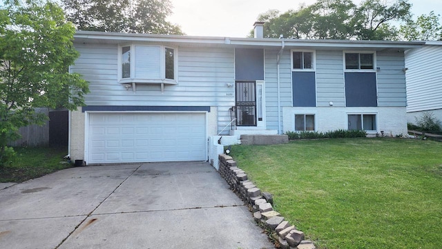 9085 N Joyce Ave, Milwaukee, WI 53224 - bi-level home featuring brick siding, a front lawn, concrete driveway, and a garage