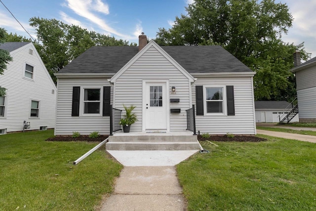 1614 N Richmond St, Appleton, WI 54911 - bungalow-style house featuring a chimney, a front yard, and a shingled roof