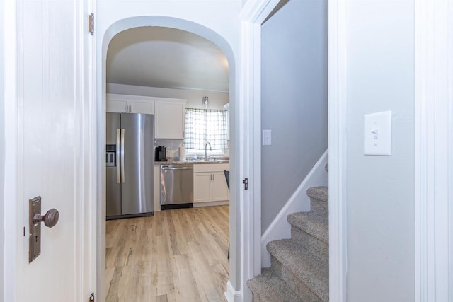 1614 N Richmond St, Appleton, WI 54911 - kitchen with appliances with stainless steel finishes, white cabinetry, light wood-type flooring, and a sink