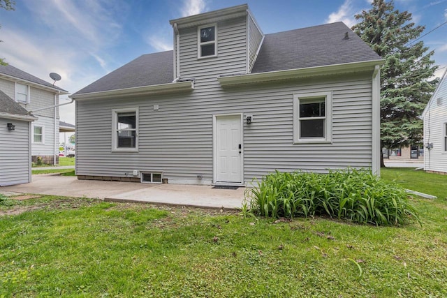 1614 N Richmond St, Appleton, WI 54911 - rear view of house featuring a lawn, a patio area, and roof with shingles