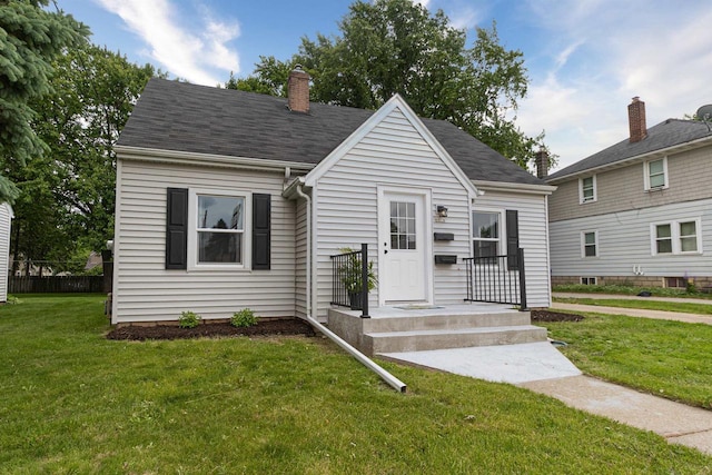 1614 N Richmond St, Appleton, WI 54911 - view of front facade with a front yard and a chimney