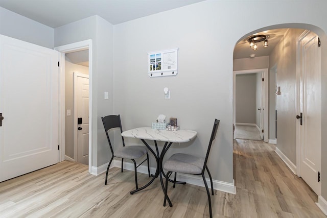 1614 N Richmond St, Appleton, WI 54911 - dining space with arched walkways, light wood finished floors, and baseboards