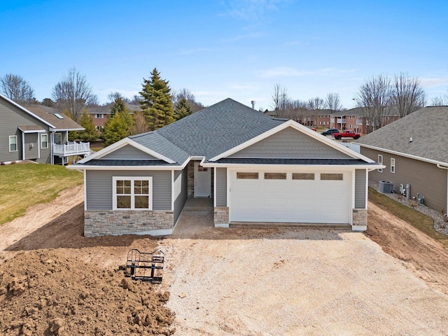 1925 Creekwood Ct, Manitowoc, WI 54220 - view of front of property with stone siding, driveway, a garage, and a residential view