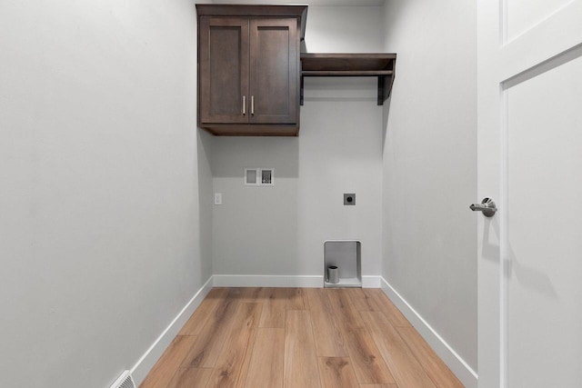 1925 Creekwood Ct, Manitowoc, WI 54220 - washroom featuring hookup for an electric dryer, light wood-type flooring, cabinet space, baseboards, and washer hookup