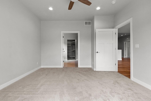1925 Creekwood Ct, Manitowoc, WI 54220 - unfurnished bedroom with carpet flooring, a spacious closet, baseboards, recessed lighting, and a ceiling fan