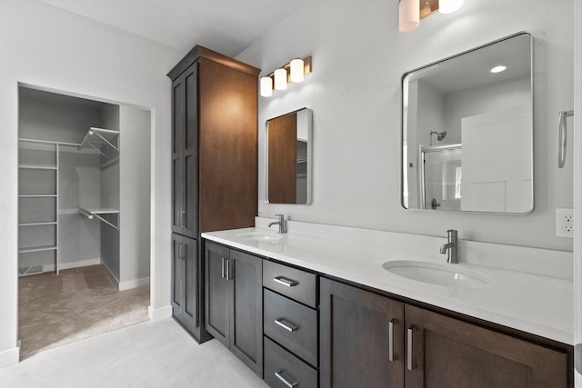 1925 Creekwood Ct, Manitowoc, WI 54220 - bathroom with double vanity, an enclosed shower, and a spacious closet