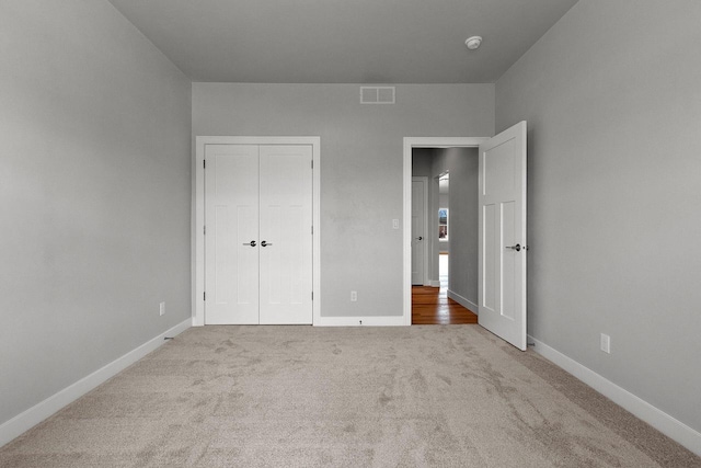 1925 Creekwood Ct, Manitowoc, WI 54220 - unfurnished bedroom featuring carpet floors, a closet, and baseboards