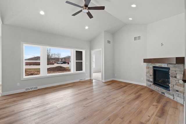 1925 Creekwood Ct, Manitowoc, WI 54220 - unfurnished living room with a ceiling fan, vaulted ceiling, light wood-style flooring, a stone fireplace, and recessed lighting