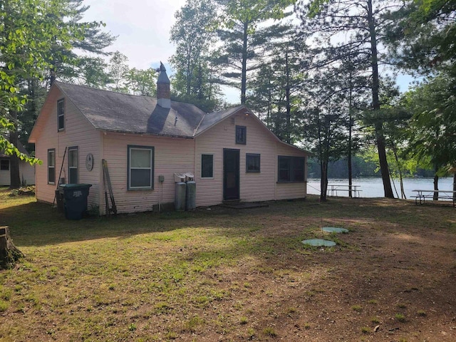 N9221 Sumac Ln, Gresham, WI 54128 - rear view of house with a chimney, a lawn, and a water view