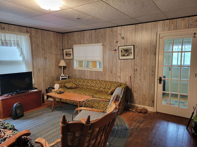 N9221 Sumac Ln, Gresham, WI 54128 - living area with wood walls, brick patterned floors, and a drop ceiling