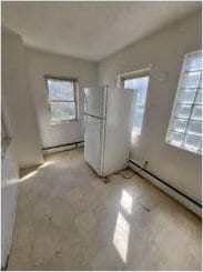 2405 S 5th St, Milwaukee, WI 53207 - spare room featuring plenty of natural light and a baseboard radiator