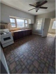 2405 S 5th St, Milwaukee, WI 53207 - kitchen with white stove, healthy amount of natural light, ceiling fan, and brick patterned flooring