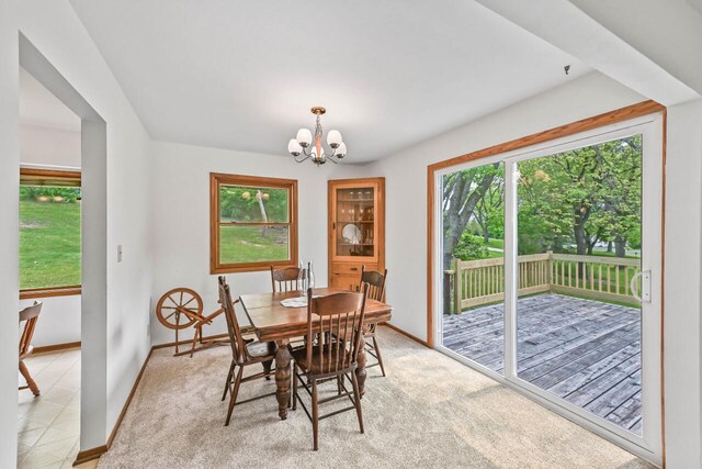 S25W27040 Winnebago Way, Waukesha, WI 53188 - dining area featuring a chandelier, plenty of natural light, baseboards, and light colored carpet