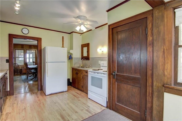 17174 59th Ave, Chippewa Falls, WI 54729 - kitchen featuring white appliances, a sink, light countertops, light wood finished floors, and crown molding